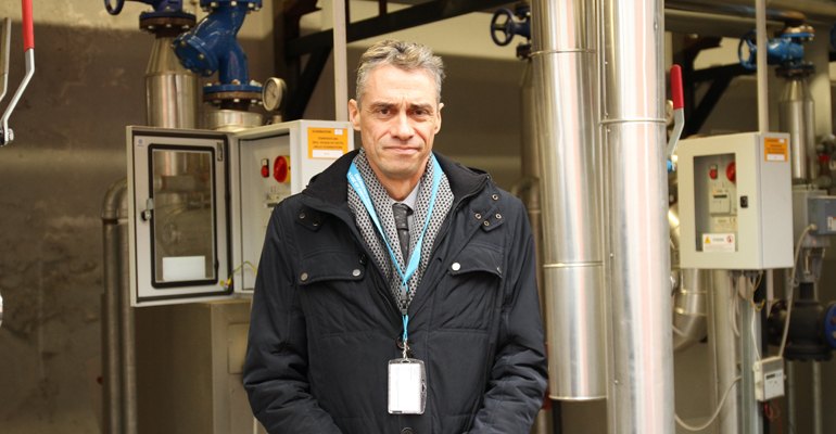 Heat delivery and transaction point, Luca Quagliani, Commercial Director for Riesco, in front of one of the metered plate exchangers at L’Oréal.