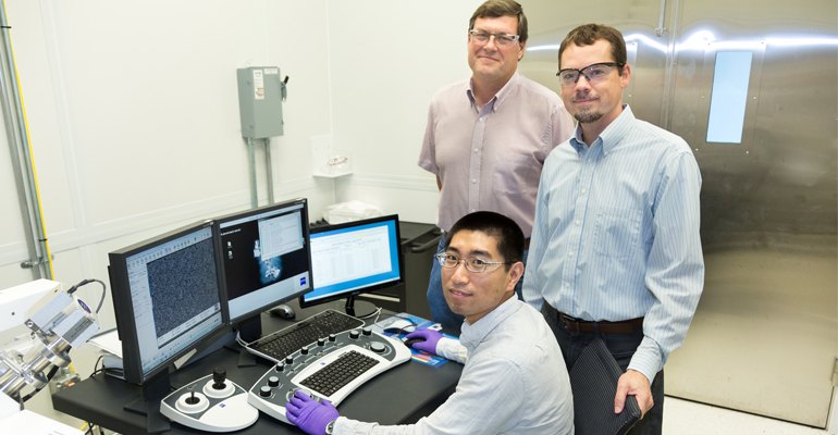 Yang Song (seated), Dale Hensley (standing left) and Adam Rondinone examine a carbon nanospike sample with a scanning electron microscope (photo courtesy ORNL).