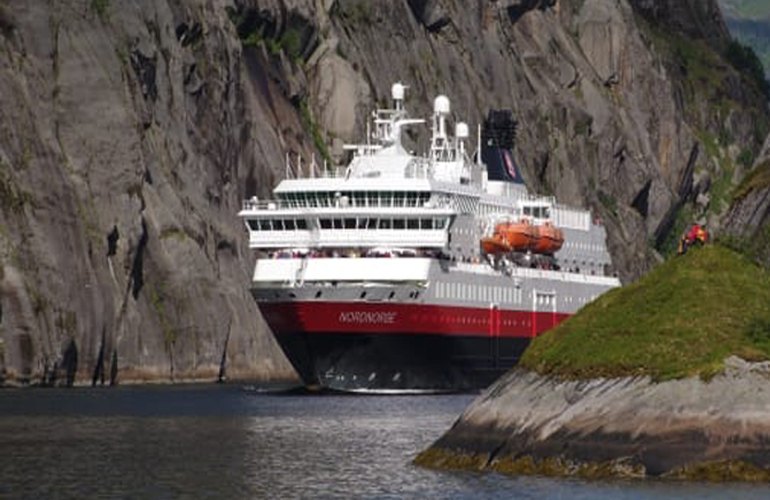 Norwegian fjords and fish farms – as the first cruise line in the world, Hurtigruten will power some of its ships with liquified biogas (LBG), a fossil-free, renewable fuel produced from residues from the fishing industry and other organic wastes (photo courtesy Hurtigruten).
