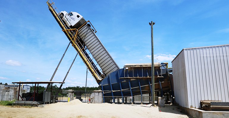 A truck unloading sawmill residuals at a wood pellet mill in the US South.